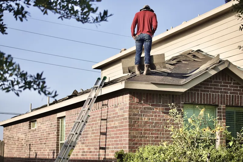 Professional roofer working on a residential roof in North Grove